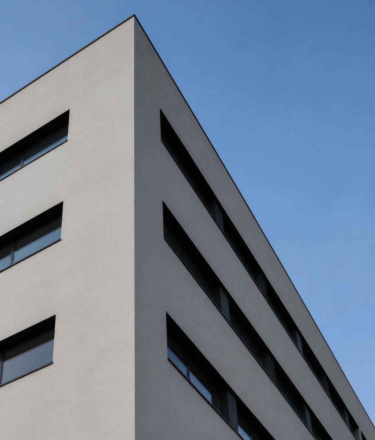Modern commercial building with a gray stucco and EIFS facade